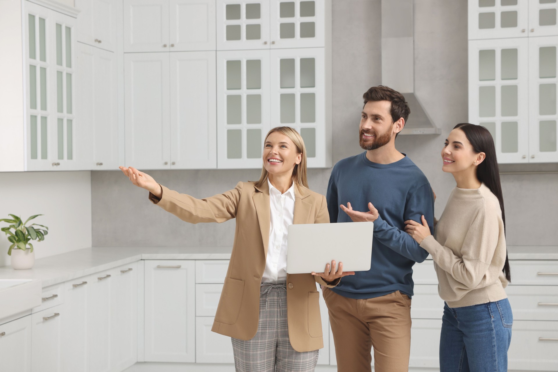 Real estate agent showing new apartment to couple